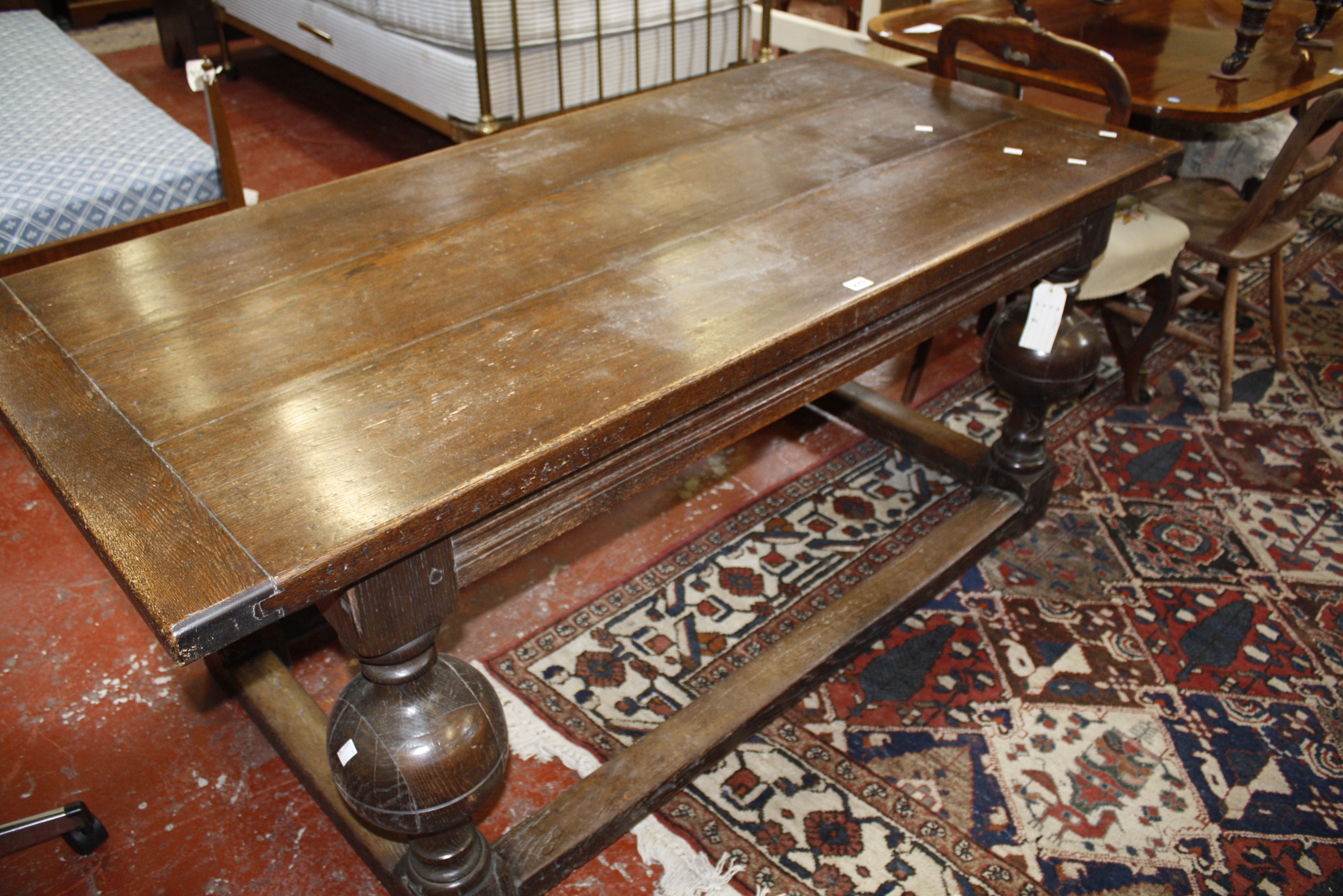 An oak plank top refectory table in the 17th century style, on bulbous supports.169cm x 78cm.
