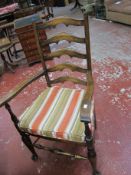 A set of four ladder back chairs with rush seats, including one carver