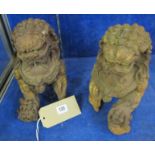 A pair of Oriental bronze coloured metal lions, 25cm high approx.