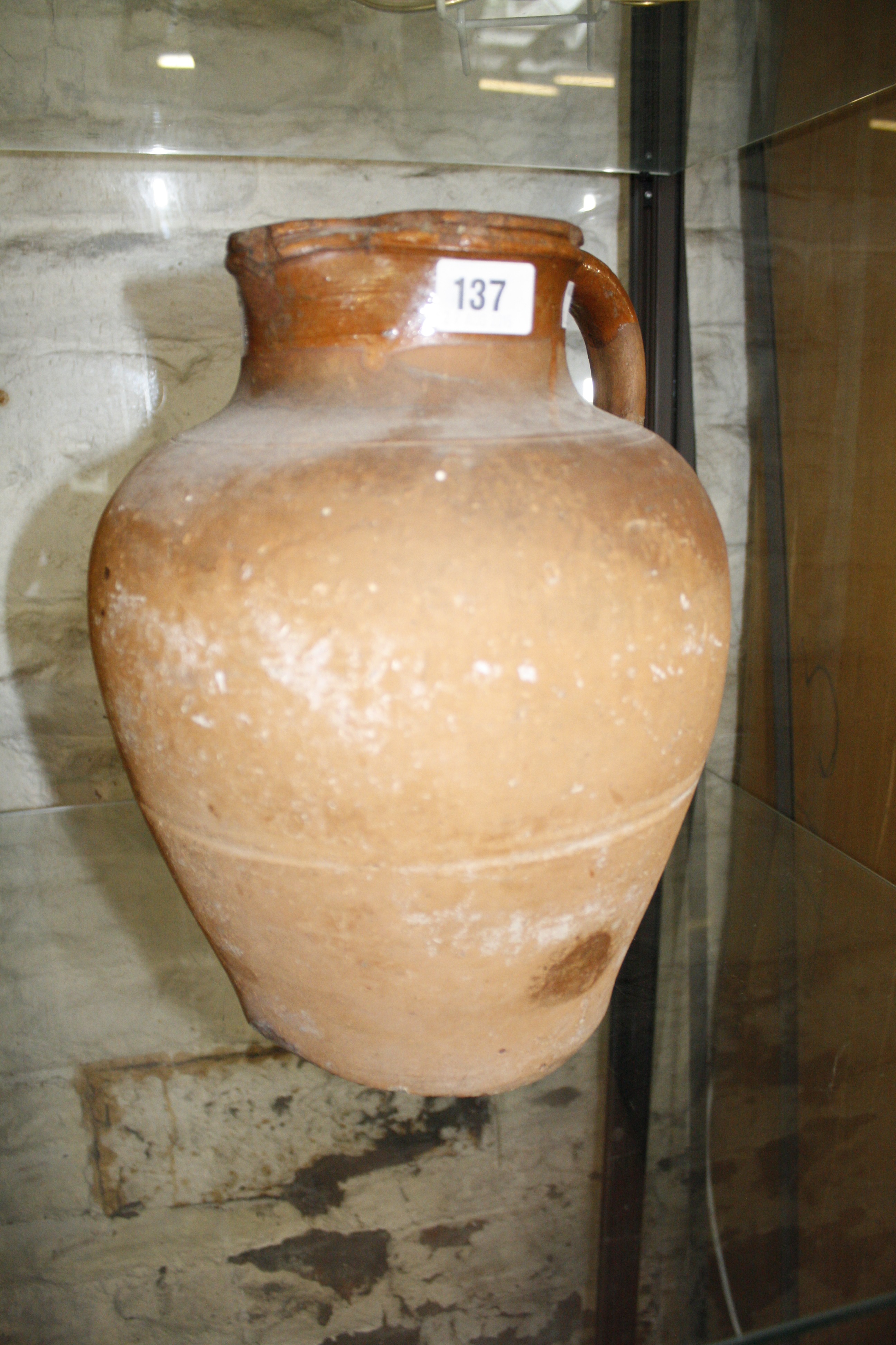 An early terracotta jug, 31cm high approx. Best Bid