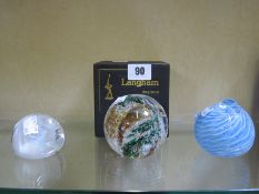 Two Edinburgh paperweights, a Langham paperweight, two other paperweights and a glass bird whistle