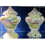 A pair of 20th Century Continental porcelain pot pourri and covers, each having fruit finial and