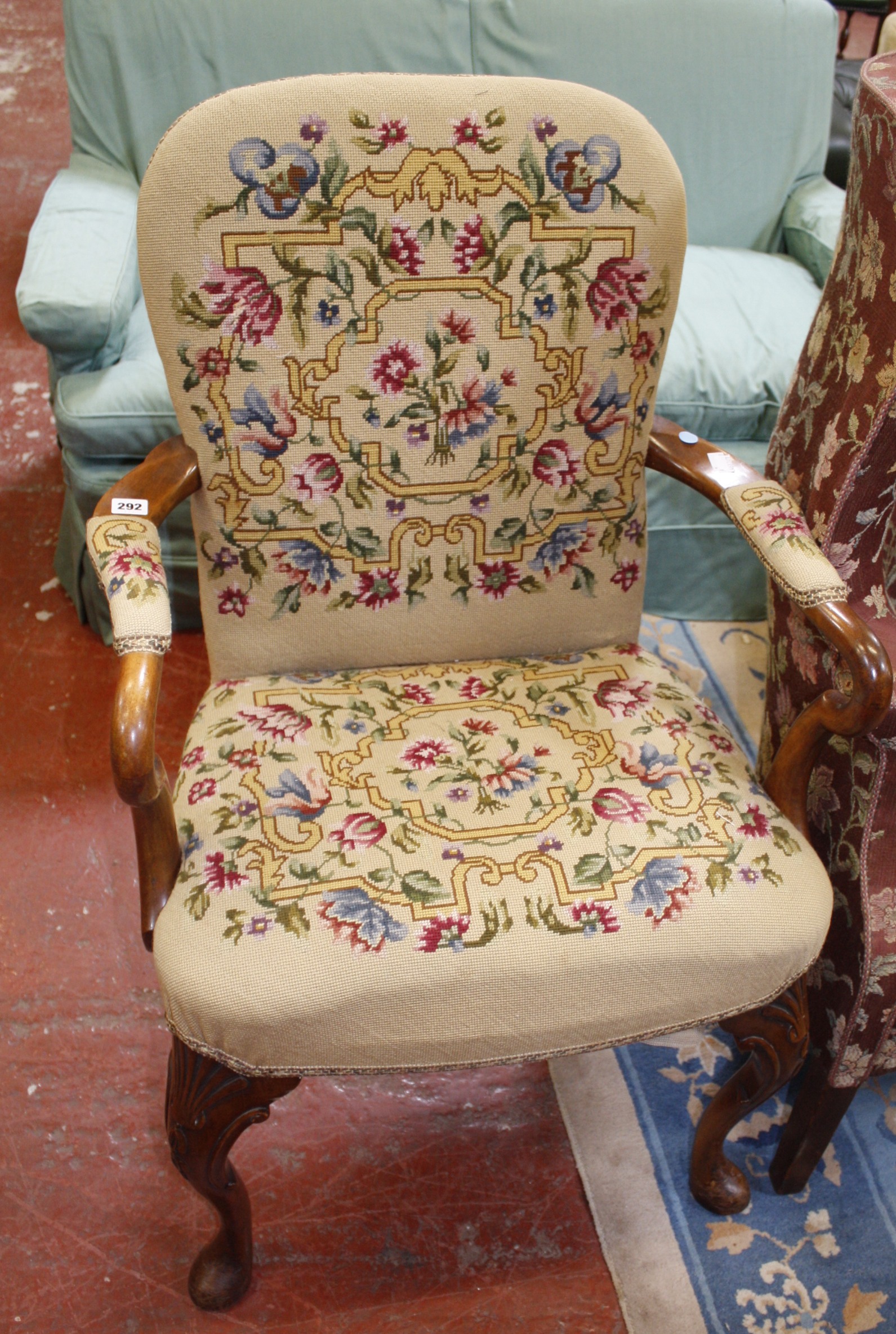 An Edwardian yew wood arm chair with tapestry back, seat and arm pads. Best Bid