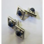 A pair of 18ct white gold and sapphire cufflinks, diamond shaped with oval shaped stones