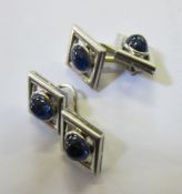 A pair of 18ct white gold and sapphire cufflinks, diamond shaped with oval shaped stones