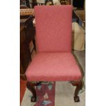 Four Georgian style dining chairs on mahogany supports with ball and claw feet, loose brown covers.