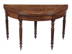 A Continental walnut folding dining table, late 18th/early 19th century, the tilt top opening to