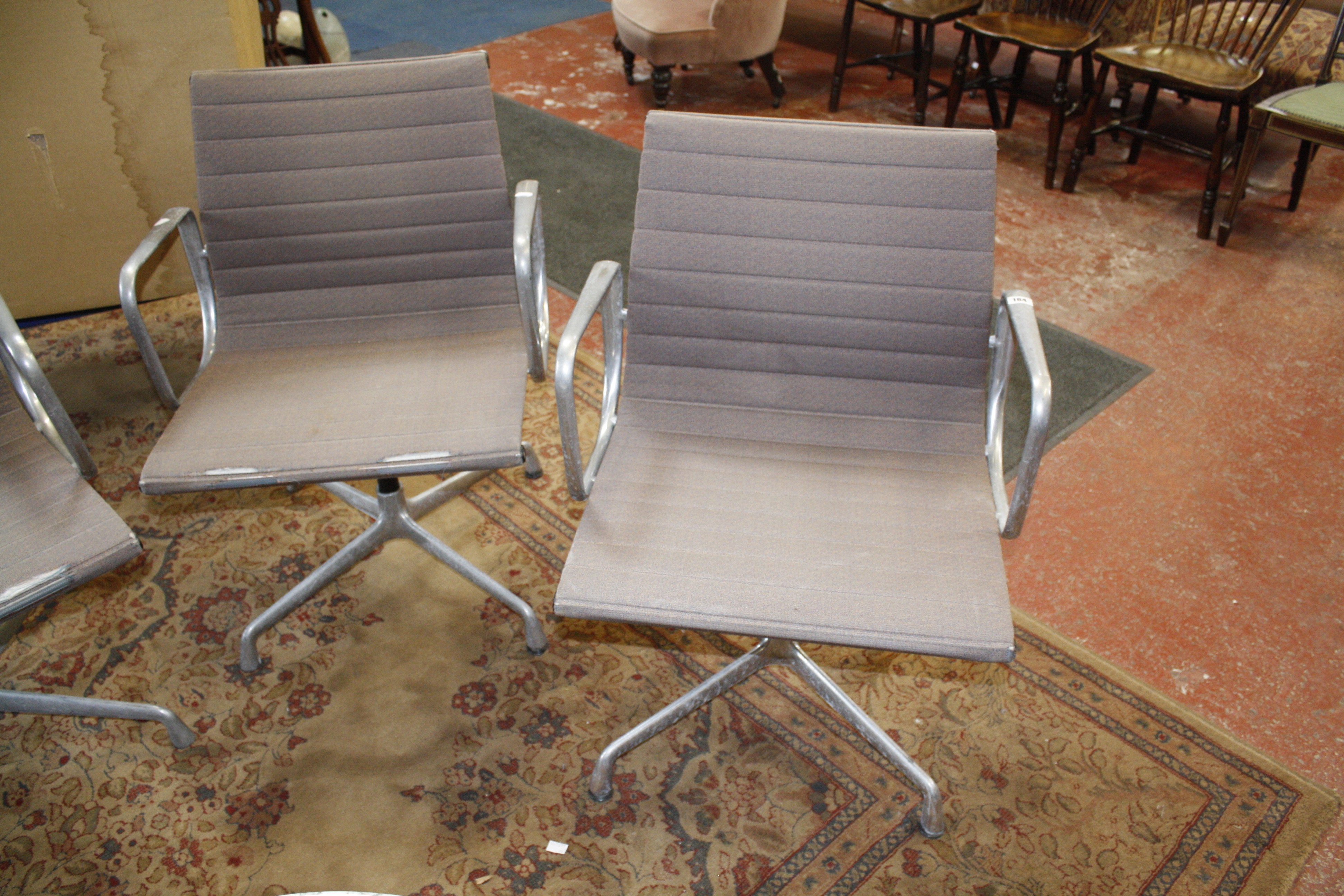 Four Charles Eames design office chairs.