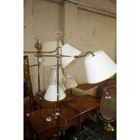 Three brass effect floor standing reading lights, and four brass effect table lamps, associate