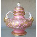 A Derby pink and gilt two-handled pot with cover, lion mask handles, 12cm high