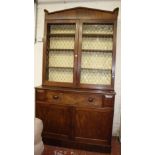 A Regency mahogany secretaire bookcase with brass grill doors to the upper section over a fitted