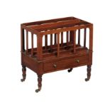 A Regency mahogany Canterbury, circa 1820, with ebony stringing, fitted a drawer and flat spindle