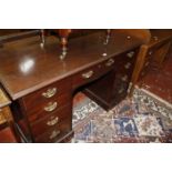 An early 19th century mahogany kneehole desk. 137cm wide x 66cm deep x 82cm high.