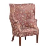 An upholstered high back tub armchair in George I style.