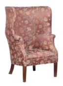 An upholstered high back tub armchair in George I style.