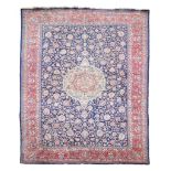 A Kirman carpet, the central medallion within a field of meandering foliage...  A Kirman carpet,