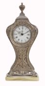 A silver coloured clock,   stamped 800, Swiss alarm movement, white dial, luminous fancy hands,