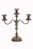 A silver three light candelabra by Mappin and Webb,   with circular sconces, baluster capitals, a