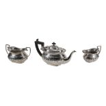 A Victorian silver three piece oblong baluster tea service by George Nathan  &  Ridley Hayes,