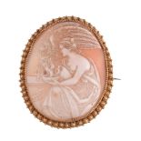 A late 19th Century shell cameo brooch,   the oval shell cameo carved with the image of Hebe and