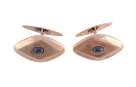 A pair of sapphire set cufflinks,   the marquise shaped panels central set with a oval shaped