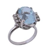 An aquamarine and diamond ring,   the central oval shaped aquamarine claw set between brilliant cut