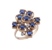 A sapphire and diamond dress ring,   the cluster panel set with oval shaped sapphires and eight cut