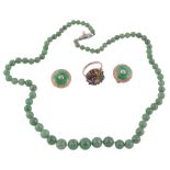 A graduated single strand jade necklace,   composed of polished jade beads on a knotted string, 52.