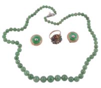 A graduated single strand jade necklace,   composed of polished jade beads on a knotted string, 52.