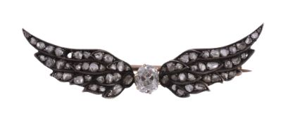 A late 19th century diamond wings brooch,   circa 1890, the central oval shaped old cut diamond