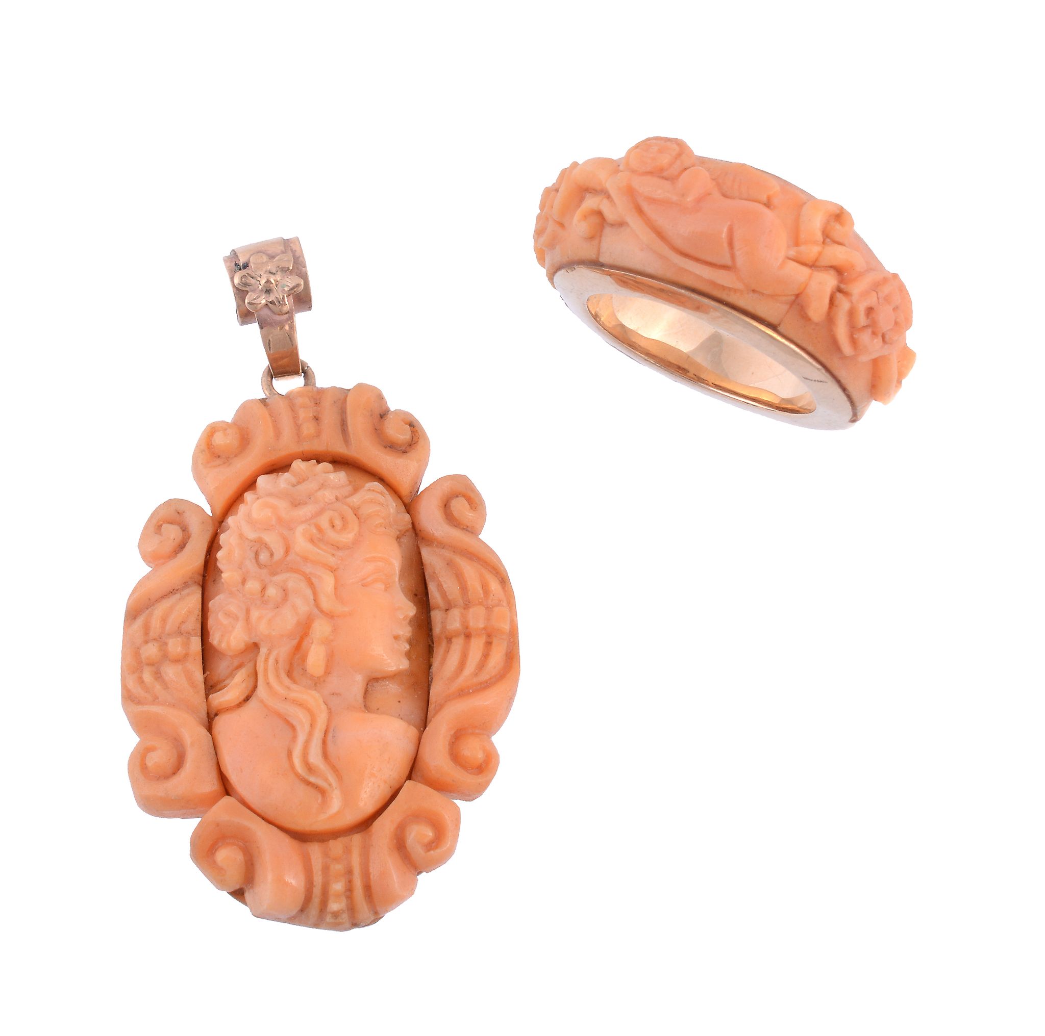 A coral pendant,   carved with the profile of a lady within a carved scroll surround, stamped 375