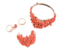 A coral bangle and brooch,   the bangle with various pieces of coral, on a gilt metal setting;