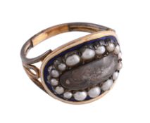 A mourning ring,   the central glazed panel with hairwork beneath, within a surround of pearls to a