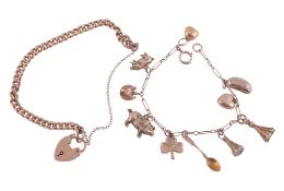 A curb link charm bracelet,   to a heart shaped padlock clasp stamped 9ct, 18cm long; together with