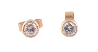 A pair of diamond ear studs,   the brilliant cut diamond in a collet setting, with post fittings,