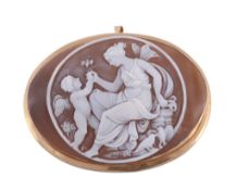 A shell cameo brooch,   the oval shell cameo carved with Cupid and Psyche, collet set with