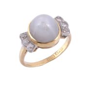 A star sapphire and diamond dress ring,   the sugarloaf cabochon star sapphire collet set between