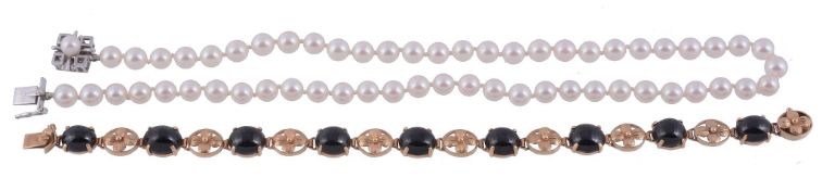 A cultured pearl necklace,   the single strand necklace composed of uniform circular shaped