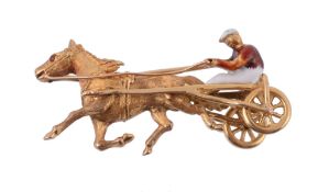 A novelty horse and trap brooch,   the Trotter horse in a trap with a red and white enamelled