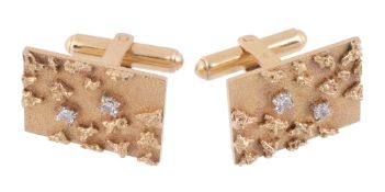 A pair of diamond cufflinks,   the rectangular textured panels set with eight cut diamonds, with t