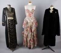 A black and gold full length Thea Porter dress; together with a vibrant floral prom dress by Frank