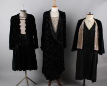 A 1920s soft black velvet dress with pink and white beaded detail; with a 1930s black georgette