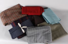 A suitcase of vintage tweed and dressmaking fabrics, including: a bolt of pale grey suiting, a large