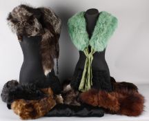 An unusual green dyed fox stole with green lame lining; together with a quantity of  fur muffs,