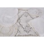 A quantity of household linens, comprising: table linens, lace and linen mats, (qty). Best Bid