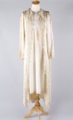 An early 20th century cream full length silk and applique lace peignoir, with silk loop fastenings