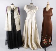 A collection of eight items of ladies evening costume, comprising: a cream satin evening gown