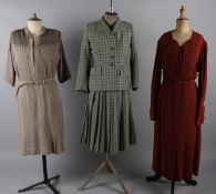 A 1940s green checked jacket with matching pleated skirt; together with a 1940s black crepe