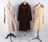 A quantity of ladies costume, comprising: a 1950s brown velvet coat with an ermine collar, a 1970s