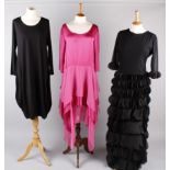 A shocking pink dress by Lungta de Fancy; with a full length black dress by the same designer with